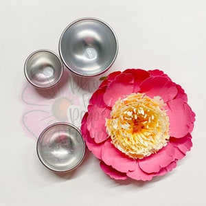 May include: Three silver metal dome molds of different sizes, with a pink paper flower in the center.