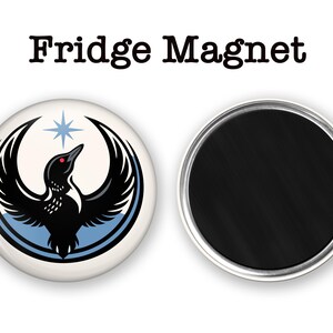 May include: A round fridge magnet with a black and white bird design, a red eye, and a blue star. The text "Fridge Magnet" is at the top. The back of the magnet is black with a silver rim.