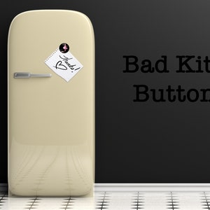 May include: A vintage-style, cream-colored refrigerator with a note that says "Thanks!" on it. The refrigerator is in front of a black wall with the text "Bad Kitty Buttons" written on it.