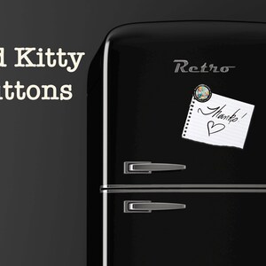 Op de afbeelding: Een zwarte retro koelkast met zilveren handgrepen en het woord "Retro" in zilveren letters. Een magneet houdt een briefje vast met "Bedankt!" en een hartje. De tekst "Bad Kitty Buttons" staat in witte letters links.