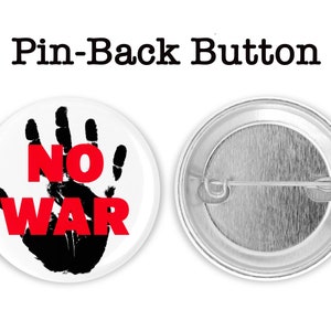 May include: A white button with a black handprint and the words "NO WAR" in red letters. The back of the button is silver with a pin.