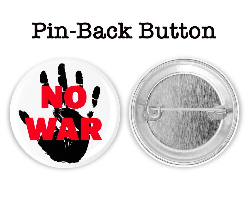 May include: A white button with a black handprint and the words "NO WAR" in red letters. The back of the button is silver with a pin.