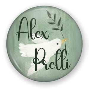 May include: A round, green button with the name "Alex Prelli" in dark green script. A white dove carrying a green olive branch is centered on the button. The background is a light green watercolor wash.