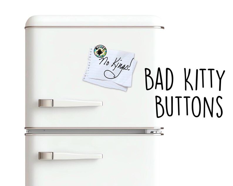May include: A white refrigerator with silver handles and the text "BAD KITTY BUTTONS" in black. A small button and a notepad with the words "No Kings!" are attached to the refrigerator.