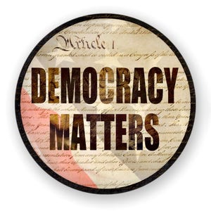 May include: A round button with a vintage American flag design and the text "DEMOCRACY MATTERS" in bold, black letters.