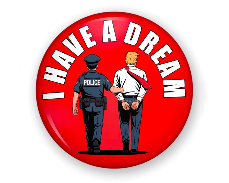 May include: A red button with the text "I HAVE A DREAM" in white. The image depicts a police officer escorting a man in handcuffs. The man is wearing a white shirt and red tie.