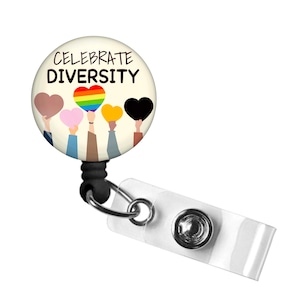May include: A white badge reel with a black retractable cord. The badge holder features a colorful design with five figures holding hearts in different colors, including rainbow, brown, pink, yellow, and black. The text "CELEBRATE DIVERSITY" is printed on the badge holder.