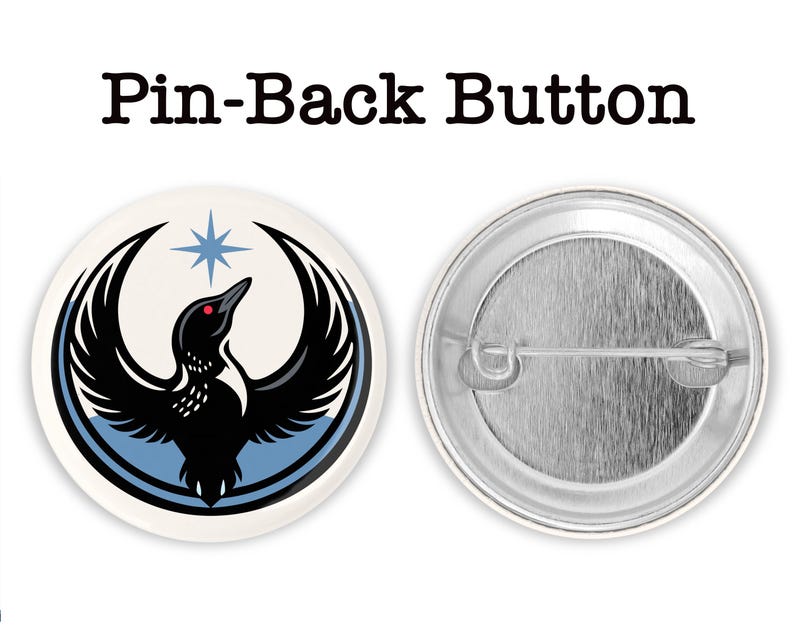 May include: A round pin-back button with a black bird design, a red eye, and a blue star. The bird has outstretched wings and is set against a white background with a blue border. The text "Pin-Back Button" is above the button.