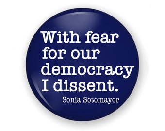 May include: A blue round button with white text that reads "With fear for our democracy I dissent. Sonia Sotomayor".