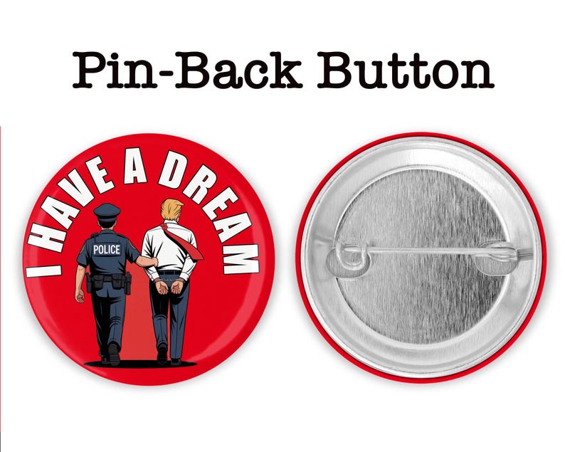 May include: Red pin-back button with the text "I HAVE A DREAM" and an illustration of a police officer escorting a man in handcuffs. The back of the button is silver. The text "Pin-Back Button" is at the top.