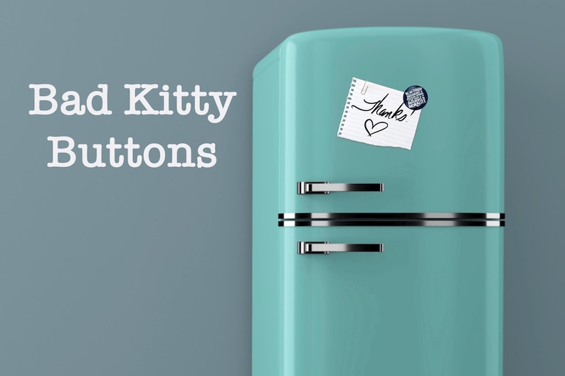 May include: A teal retro refrigerator with silver handles and a horizontal silver stripe. A small notepad with the word "Thanks" and a heart is attached with a paperclip. A round button is also attached to the refrigerator. The words "Bad Kitty Buttons" are on the left.