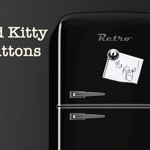 May include: A black retro refrigerator with silver handles and trim. A magnet holds a note that reads "No Kings!". The words "Bad Kitty Buttons" are in white text on the left side of the image.