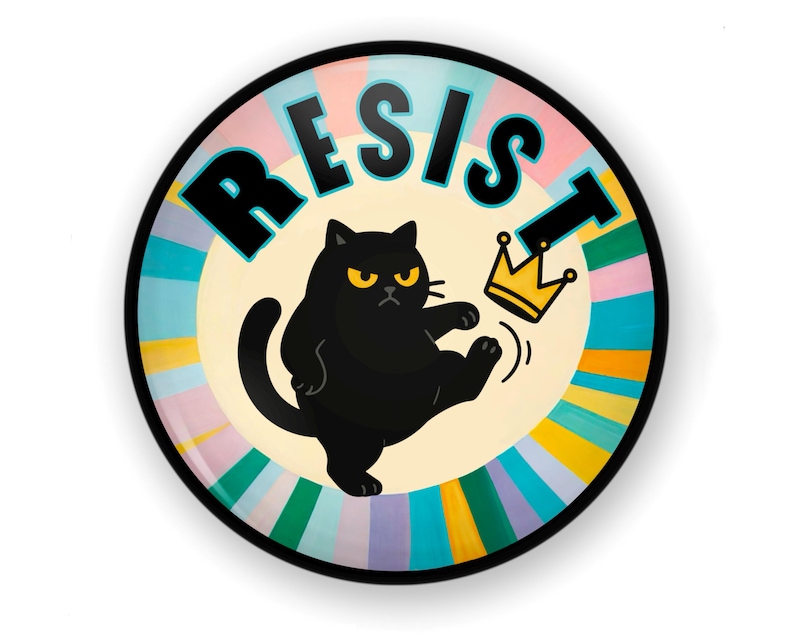 May include: A round decorative plate with the word "RESIST" in black block letters. A black cat with yellow eyes kicks a gold crown. The background has a radial design with pastel colors.