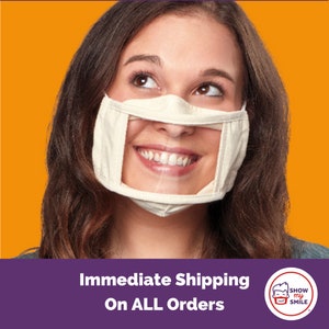 May include: A woman wearing a beige face mask with a clear plastic window that allows her to show her smile. The mask has the text "Show My Smile" on the side. The background is a solid orange color.