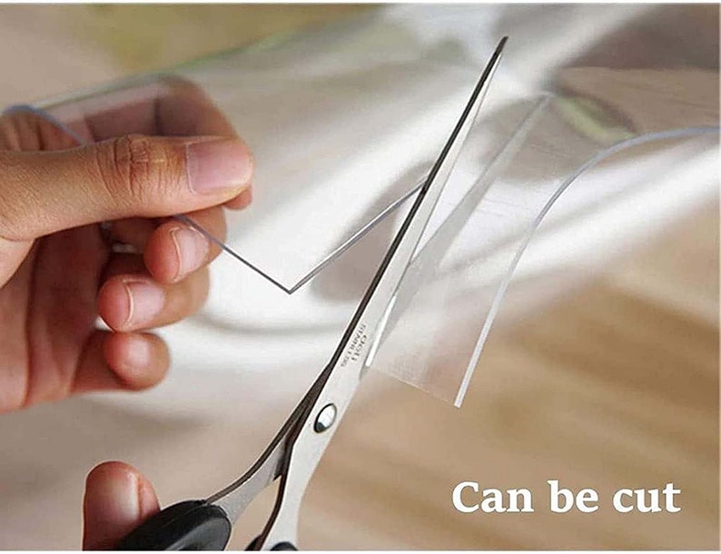 May include: A pair of silver scissors cutting a clear plastic sheet. The text "Can be cut" is visible in the image.