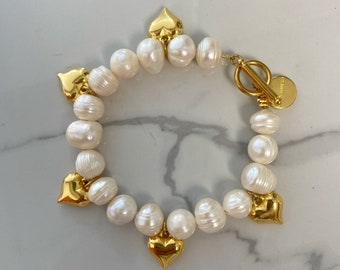 Large pearl bracelet, gold tone puffy hearts bracelet, multi charm bracelet, toggle bracelet .hearts bracelet, big pearl beaded
