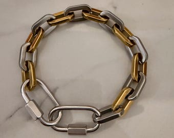 Bracciale moderno oversize da uomo con moschettone in oro e argento misto.