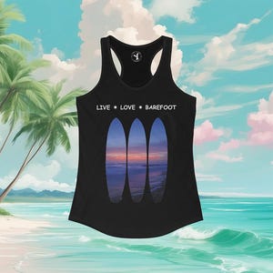 May include: Black tank top with a beach scene design. The tank top features three surfboard silhouettes with a sunset image. The words "LIVE • LOVE • BAREFOOT" are printed across the top.