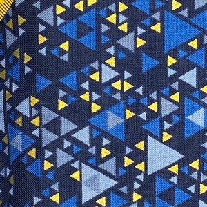 May include: A navy blue fabric with a geometric pattern of yellow, blue, and gray triangles.