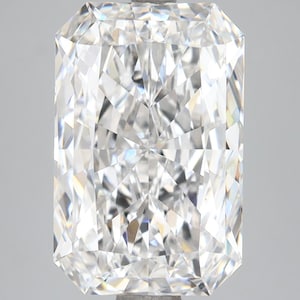 May include: A large, rectangular-cut diamond with numerous facets, reflecting light. The gemstone is clear and colorless, showcasing its internal structure and brilliance. The diamond's shape is elongated, with a symmetrical arrangement of facets.