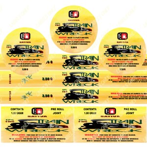 May include: A yellow and red label with the words "Train Wreck" and "Sativa" printed on it. The label also includes a graphic of a train and the text "1.00 gram" and "Pre Roll Joint".
