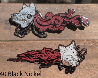 May include: Two black nickel enamel pins featuring a stylized white fox head with red flames. The fox head is detailed with black eyes and a black nose. The flames are stylized and have a swirling pattern. The text "40 Black Nickel" is visible at the bottom of the image.