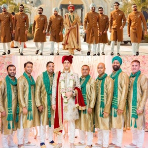 May include: Two groups of men wearing traditional Indian clothing. The first group is wearing brown kurtas with white pants and turbans. The second group is wearing gold kurtas with white pants and green scarves. Both groups are smiling and looking at the camera.