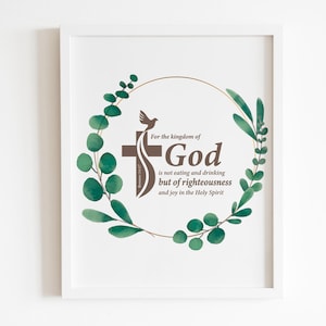 May include: A white framed print with a green leafy wreath surrounding a brown cross and a dove. The text reads "For the kingdom of God is not eating and drinking but of righteousness and joy in the Holy Spirit."
