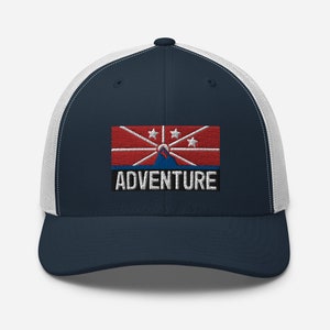 May include: A navy blue and white trucker hat with a red, white, and blue flag and the word "ADVENTURE" embroidered on the front.