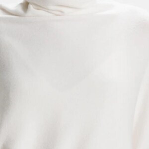 Roll Neck Draped Asymmetric Jumper by Alpini Knitwear Ivory