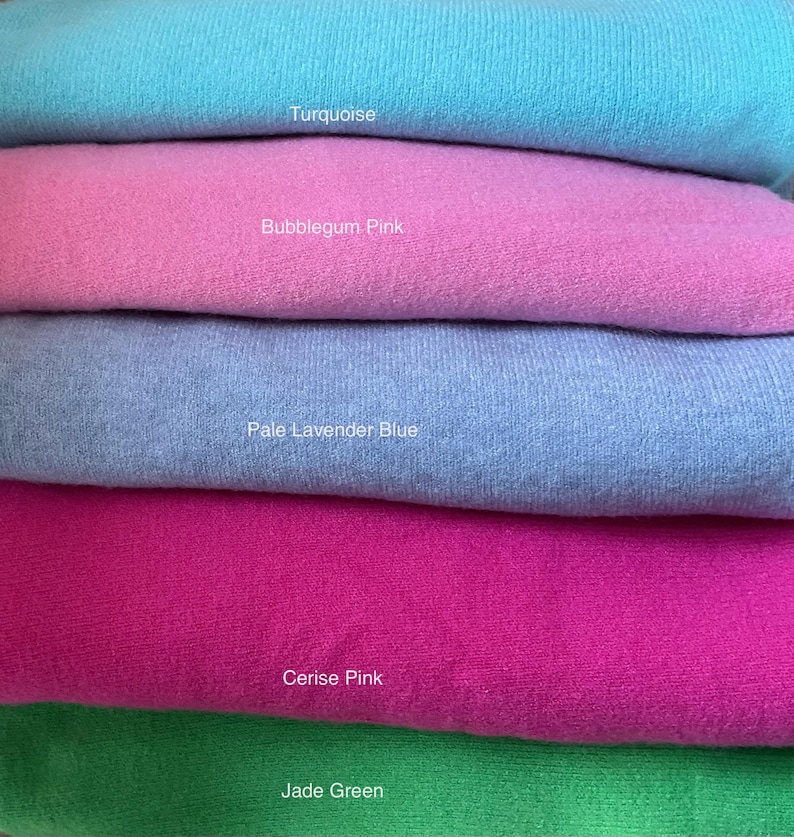 May include: Five fabric swatches stacked on top of each other. The swatches are turquoise, bubblegum pink, pale lavender blue, cerise pink, and jade green.