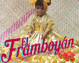 May include: A doll wearing a yellow and gold dress with a matching head wrap and shawl. The doll has dark skin and curly hair. The text "EL Framboyán" is displayed in a colorful font.