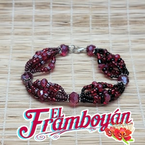 May include: A beaded bracelet featuring a mix of red and black beads. The bracelet has a multi-strand design with faceted crystal accents and a silver-tone clasp. The text "El Framboyán" is displayed in a stylized font.