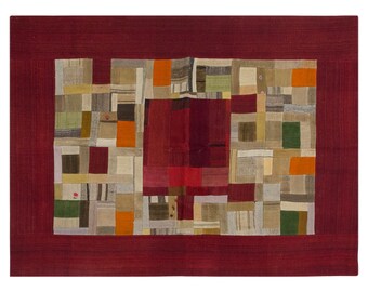 May include: Rectangular patchwork rug with a deep red border. The central design features a mosaic of various fabric squares in shades of red, orange, green, and beige. The rug's texture suggests a handcrafted, vintage aesthetic.
