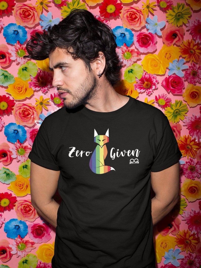 May include: A black t-shirt with a rainbow fox graphic and the text "Zero Given" in white. The fox is sitting with its tail curled around its body.