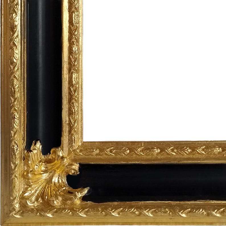 Op de afbeelding: Close-up van een decoratieve fotolijst met een zwart interieur en een sierlijke goudkleurige rand. De lijst heeft gedetailleerde reli&euml;fpatronen en een klassiek ontwerp, geschikt voor kunstwerken of foto's.