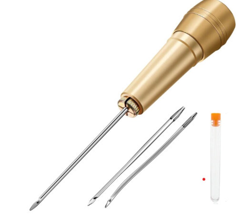 May include: Gold leather sewing awl with a long, thin needle and two additional needles in a clear plastic tube. The awl is used for hand-stitching leather.