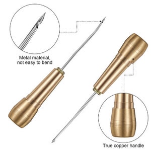 May include: A gold-toned leather sewing awl with a metal needle and a copper handle. The needle is sharp and the handle is sturdy. The awl is used for sewing leather and other thick materials.