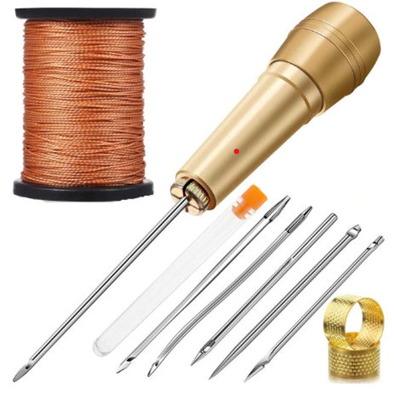 May include: A set of leather sewing tools including a gold-colored awl, six needles, a spool of orange thread, and a thimble.