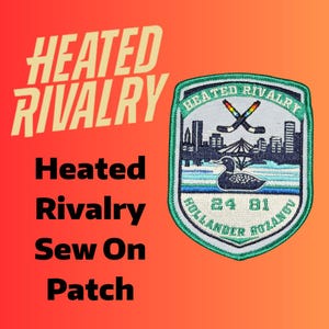 May include: A sew-on patch with the words "Heated Rivalry" in a bold, stylized font. The patch features a green and white shield design with crossed hockey sticks, a cityscape, and a loon. The text "24 81" and "Hollander Rozanov" are also included.