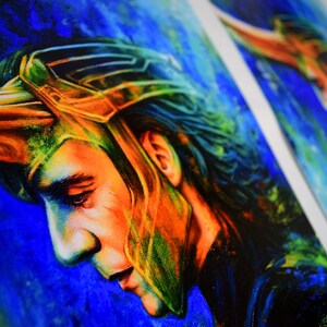 May include: A colourful painting of a man with long dark hair wearing a gold helmet. The background is a blue and green nebula.