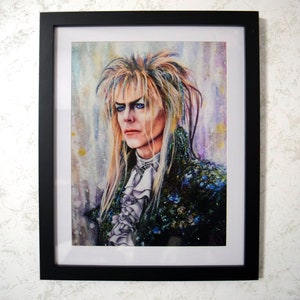 May include: A watercolor painting of a man with long, blonde hair and blue eyes. He is wearing a dark blue and green jacket with a white ruffled shirt. The background is a watercolor wash of purple, blue, and yellow.