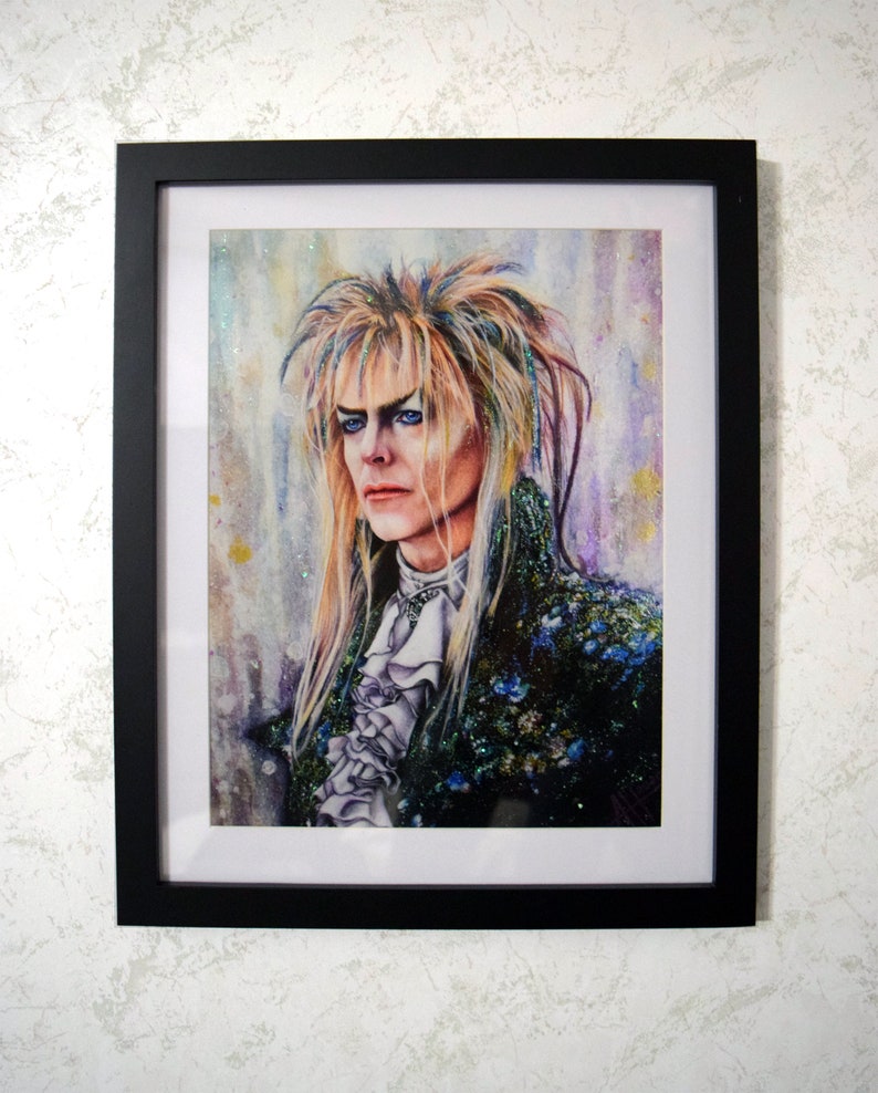 May include: A watercolor painting of a man with long, blonde hair and blue eyes. He is wearing a dark blue and green jacket with a white ruffled shirt. The background is a watercolor wash of purple, blue, and yellow.