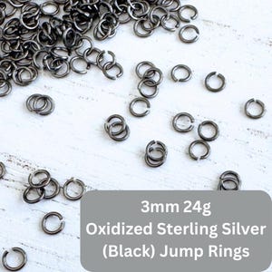 May include: A pile of 3mm oxidized sterling silver jump rings, also known as black jump rings.