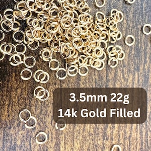 May include: A close-up of a pile of 3.5mm gold-filled jump rings. The rings are 22g and are 14k gold filled.