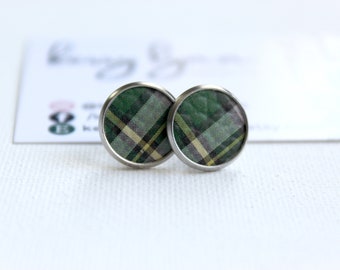 May include: A pair of silver stud earrings with a green, white and yellow tartan pattern.