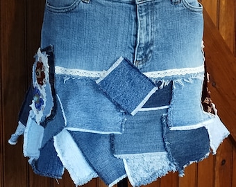 May include: A denim skirt made from repurposed denim scraps. The skirt has a patchwork design with frayed edges and a white lace trim.