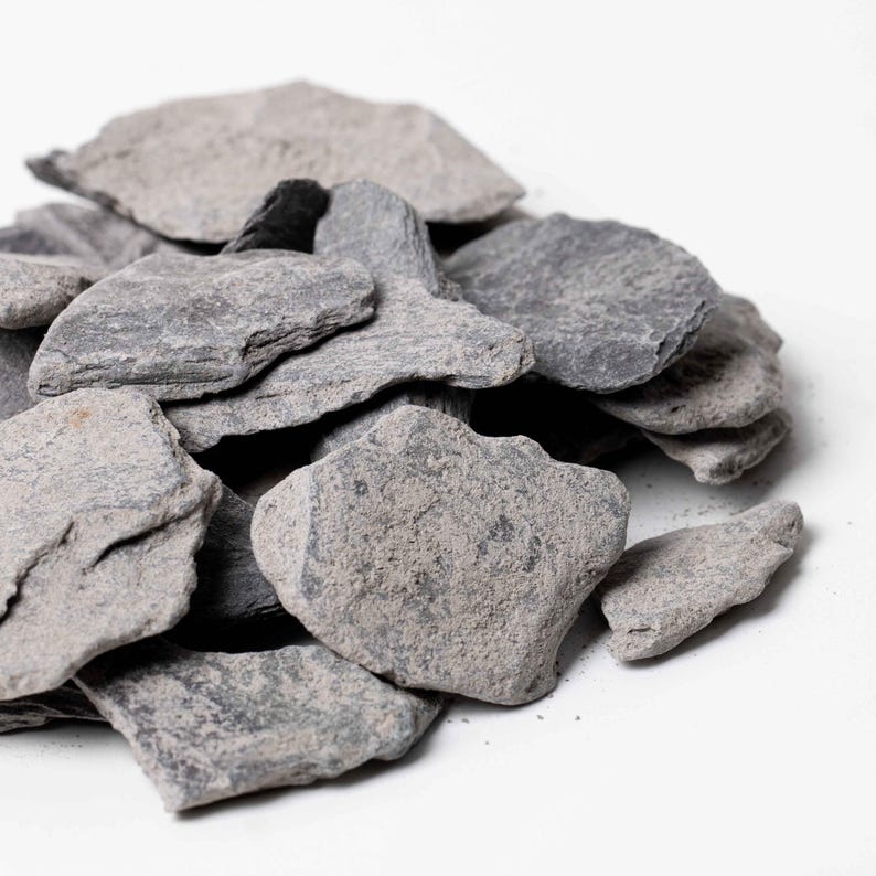 Natural slate stone pieces, perfect for terrariums and aquariums, offering a flat, textured surface for decorative or structural use.