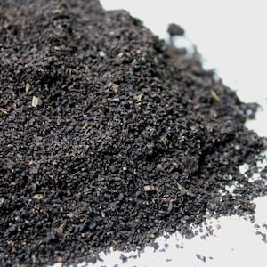 May include: A close-up of a pile of dark brown compost, a rich soil amendment for gardening.