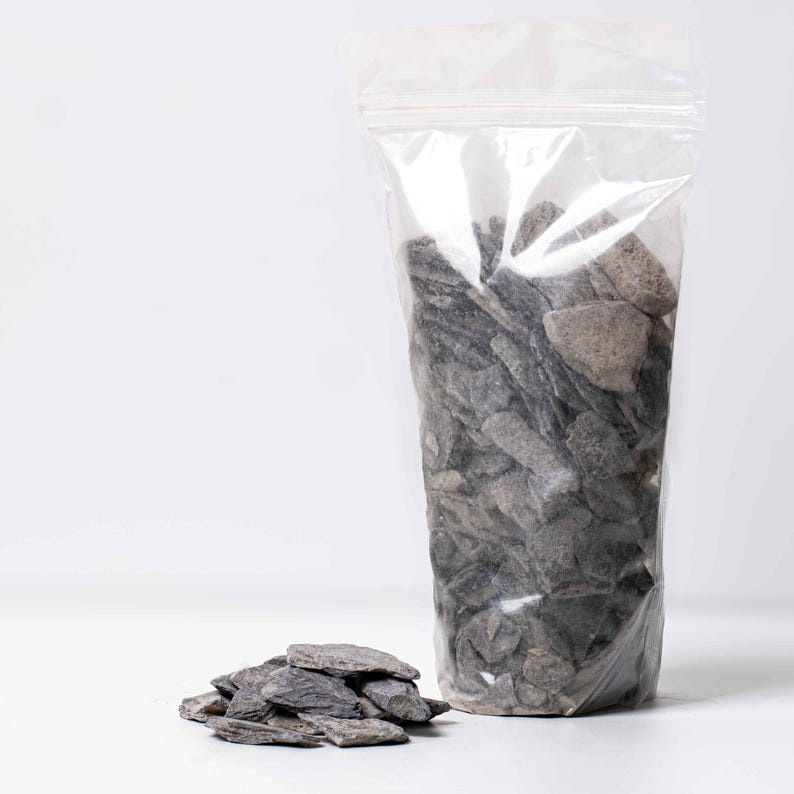 Decorative slate stones shown in a terrarium setup, providing natural texture and aesthetic for plant lovers and aquarium hobbyists.